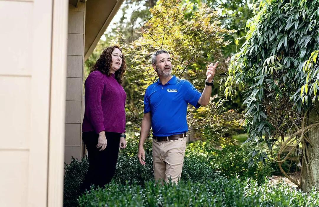 Bartlett arborist pointing out trees to a homeowner