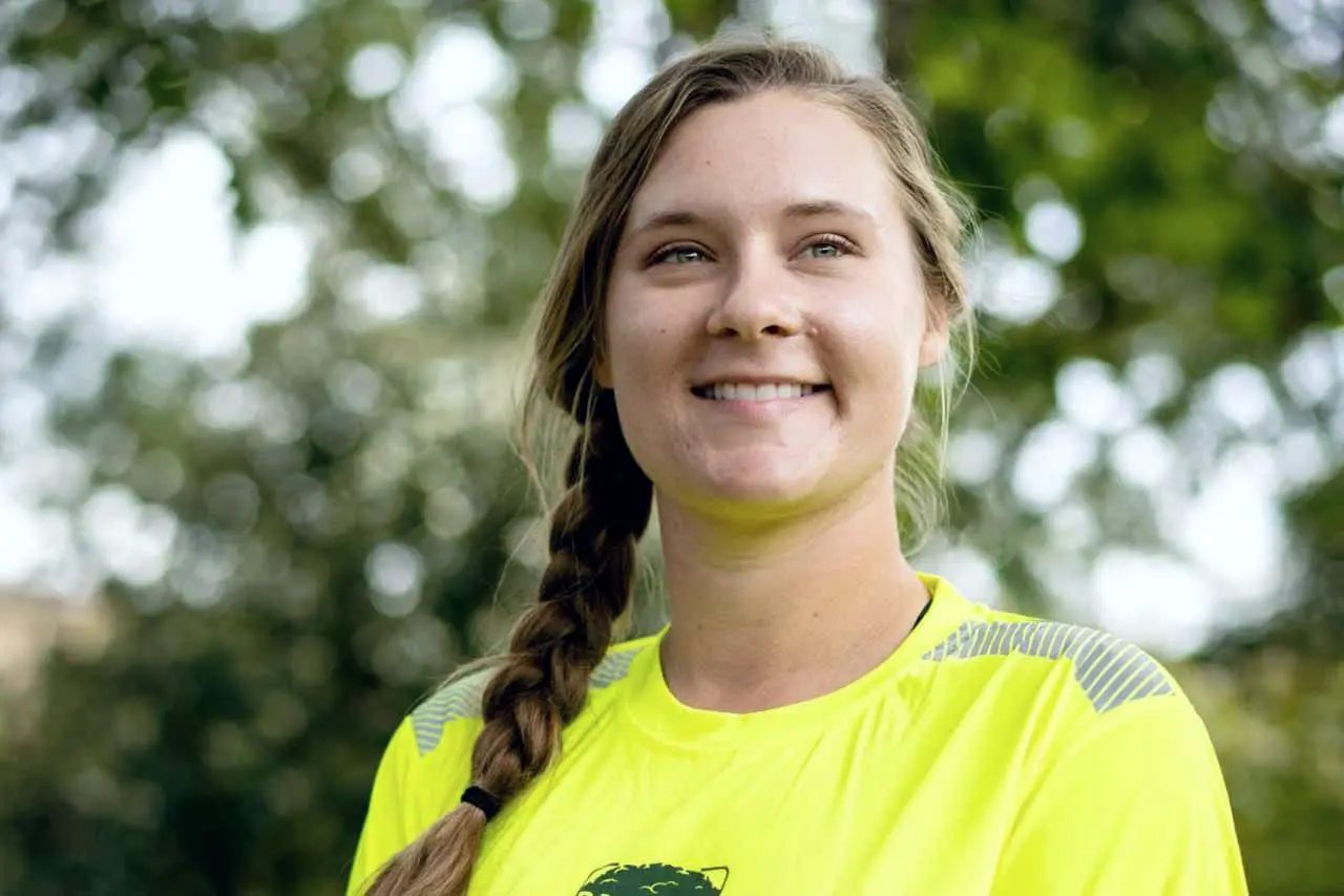Smiling Bartlett arborist in a high-visibility shirt outdoors