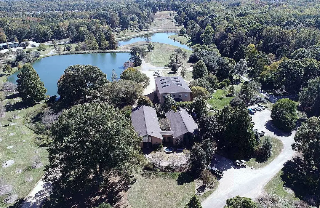 Aerial view of the Bartlett Tree Research Laboratories campus among trees and ponds